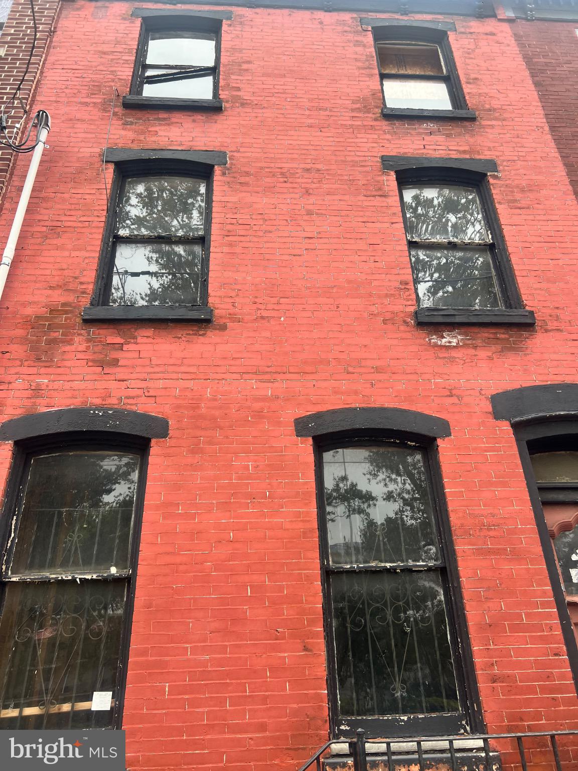 a front view of a brick building with a small yard