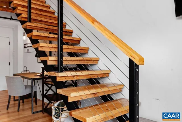 a view of entryway with wooden floor and cabinets