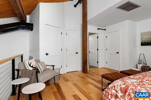 a bedroom with bed and a furniture