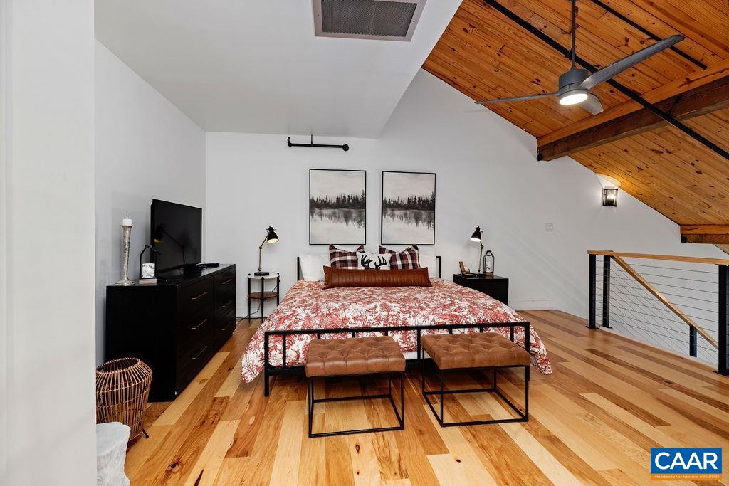 163 Mountain Inn Loop Roseland, VA 22967 - Photo 15 of 24 a bedroom with a bed and wooden floor