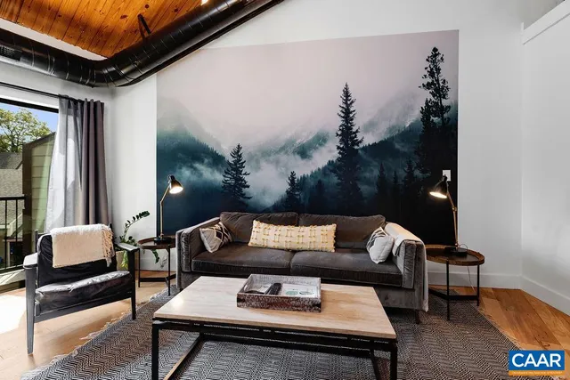 a living room with furniture and wooden floor