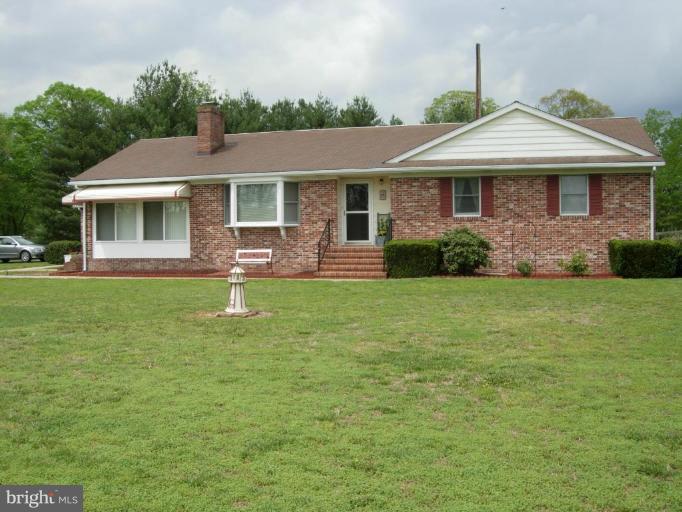 9789 Pearson Road Denton, MD 21629 - Photo 1 of 29 a front view of a house with a yard
