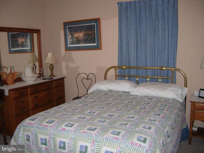 9789 Pearson Road Denton, MD 21629 - Photo 12 of 29 a bedroom with a bed and cabinet