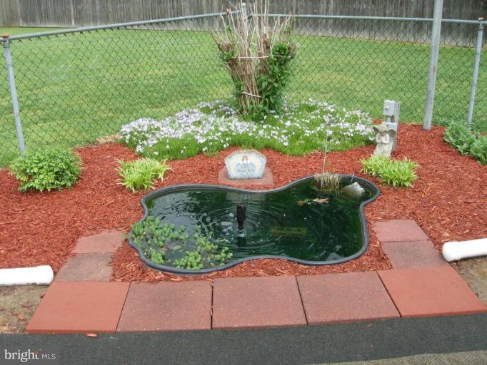 9789 Pearson Road Denton, MD 21629 - Photo 13 of 29 a view of a garden with a patio