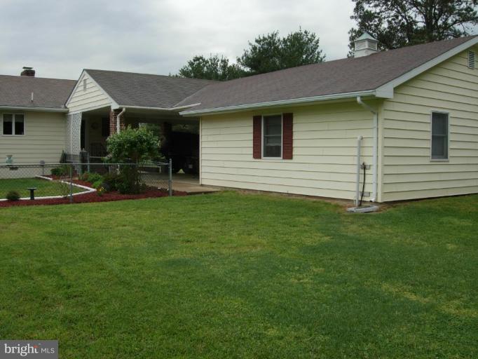 9789 Pearson Road Denton, MD 21629 - Photo 18 of 29 a front view of a house with a garden and yard