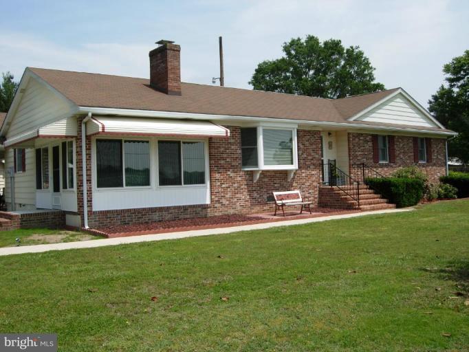 9789 Pearson Road Denton, MD 21629 - Photo 19 of 29 a front view of a house with a garden