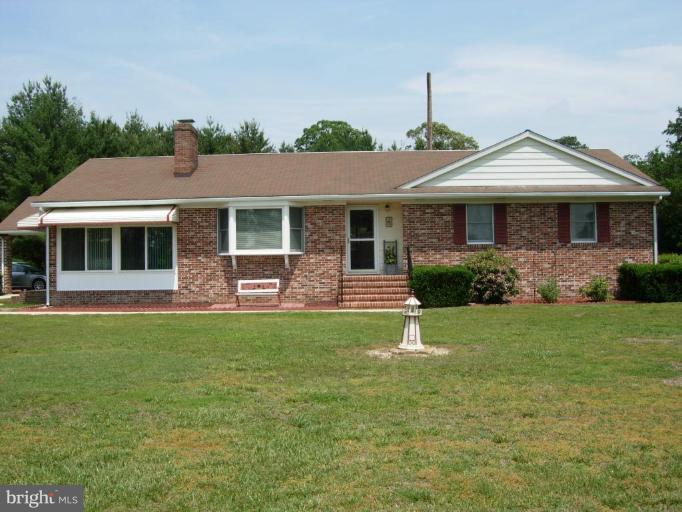 9789 Pearson Road Denton, MD 21629 - Photo 22 of 29 a front view of a house with a garden