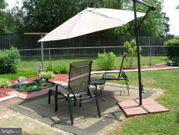 9789 Pearson Road Denton, MD 21629 - Photo 24 of 29 a view of a chair and table in backyard