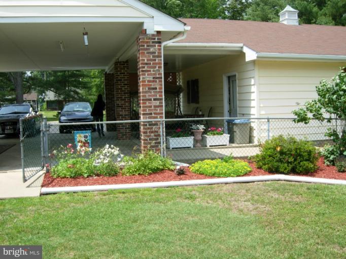 9789 Pearson Road Denton, MD 21629 - Photo 27 of 29 a front view of a house with garden
