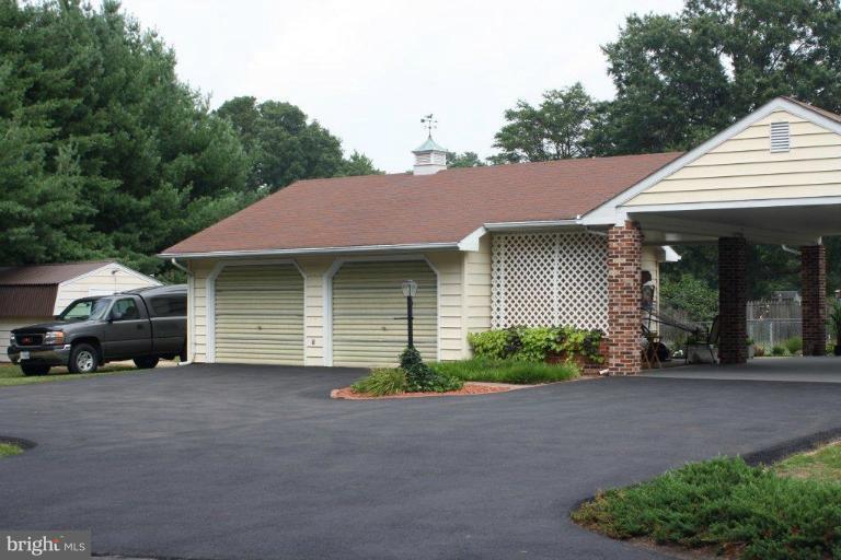 9789 Pearson Road Denton, MD 21629 - Photo 29 of 29 a front view of a house with a yard and garage