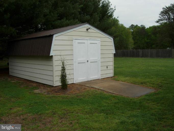 9789 Pearson Road Denton, MD 21629 - Photo 6 of 29 a front view of a house with a yard
