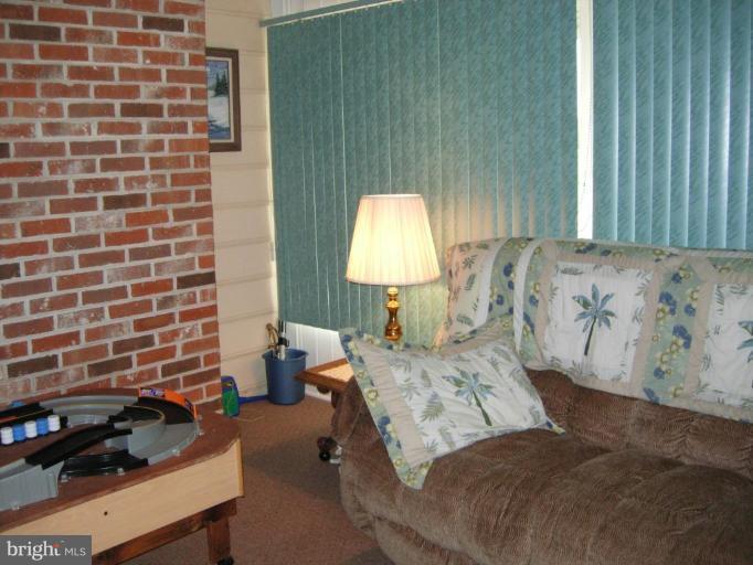 9789 Pearson Road Denton, MD 21629 - Photo 7 of 29 a bedroom with a bed and a lamp