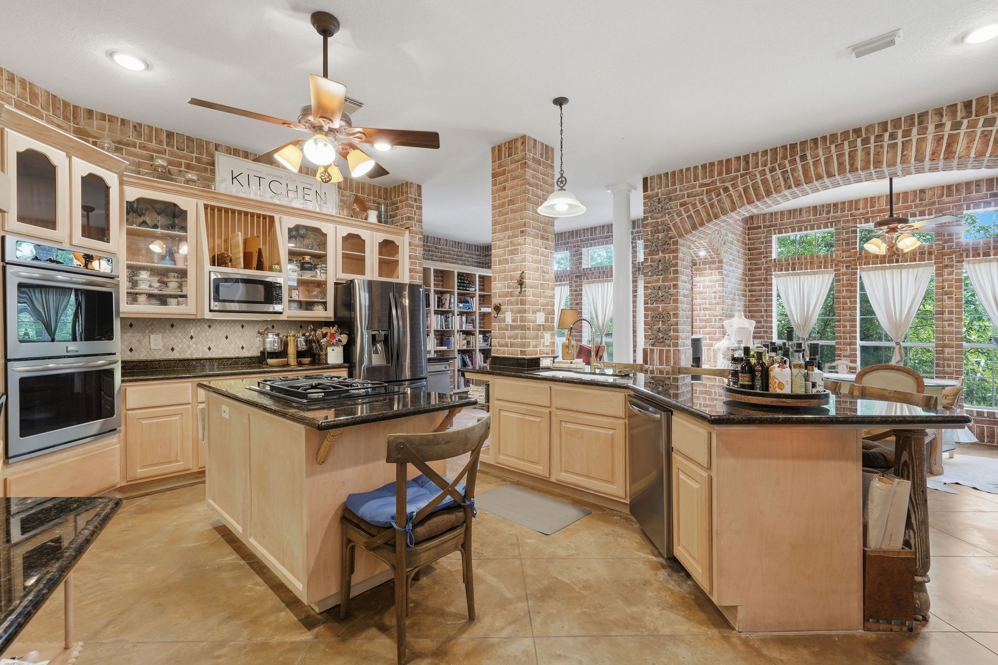 25014 Northampton Terrace Drive Spring, TX 77389 - Photo 15 of 50 The kitchen designed for the chef in your family! The center island provides a gas cooktop and prep area. A double oven convenient for large dinner parties. Solid wood cabinetry