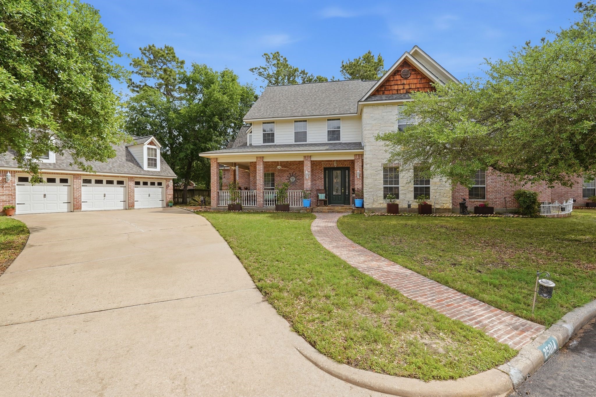25014 Northampton Terrace Drive Spring, TX 77389 - Photo 2 of 50 Triple wide driveway provides ample parking. And the brick paver walkway to the front door welcomes you home.
