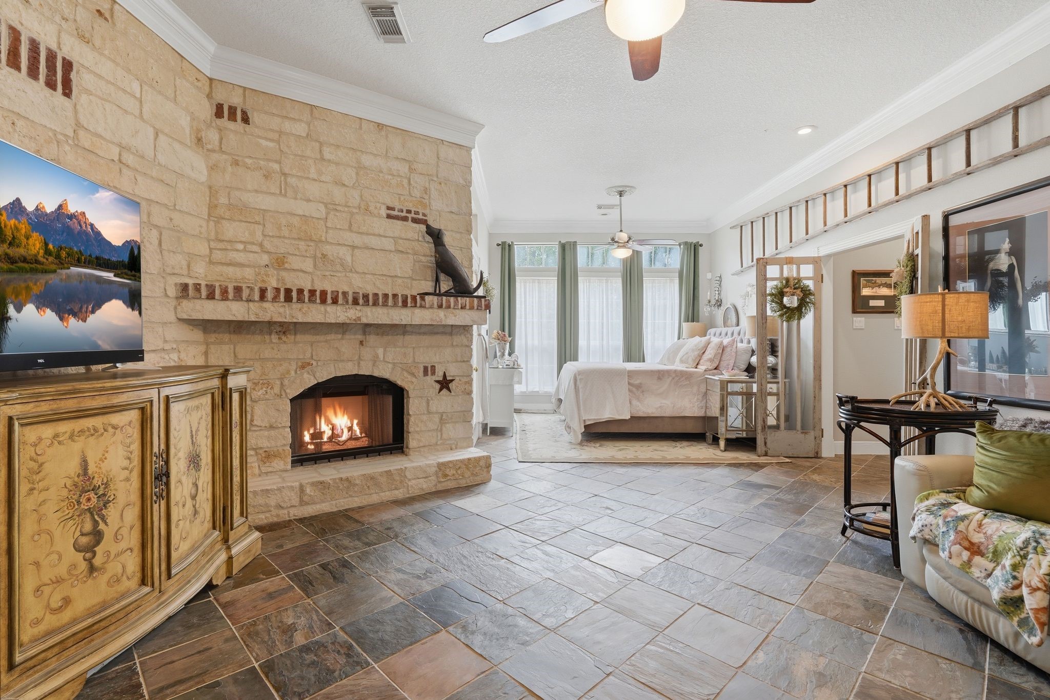 25014 Northampton Terrace Drive Spring, TX 77389 - Photo 24 of 50 The sitting area in the primary bedroom complete with a woodburning fireplace, stone walls and slate flooring. You can relax here for hours!