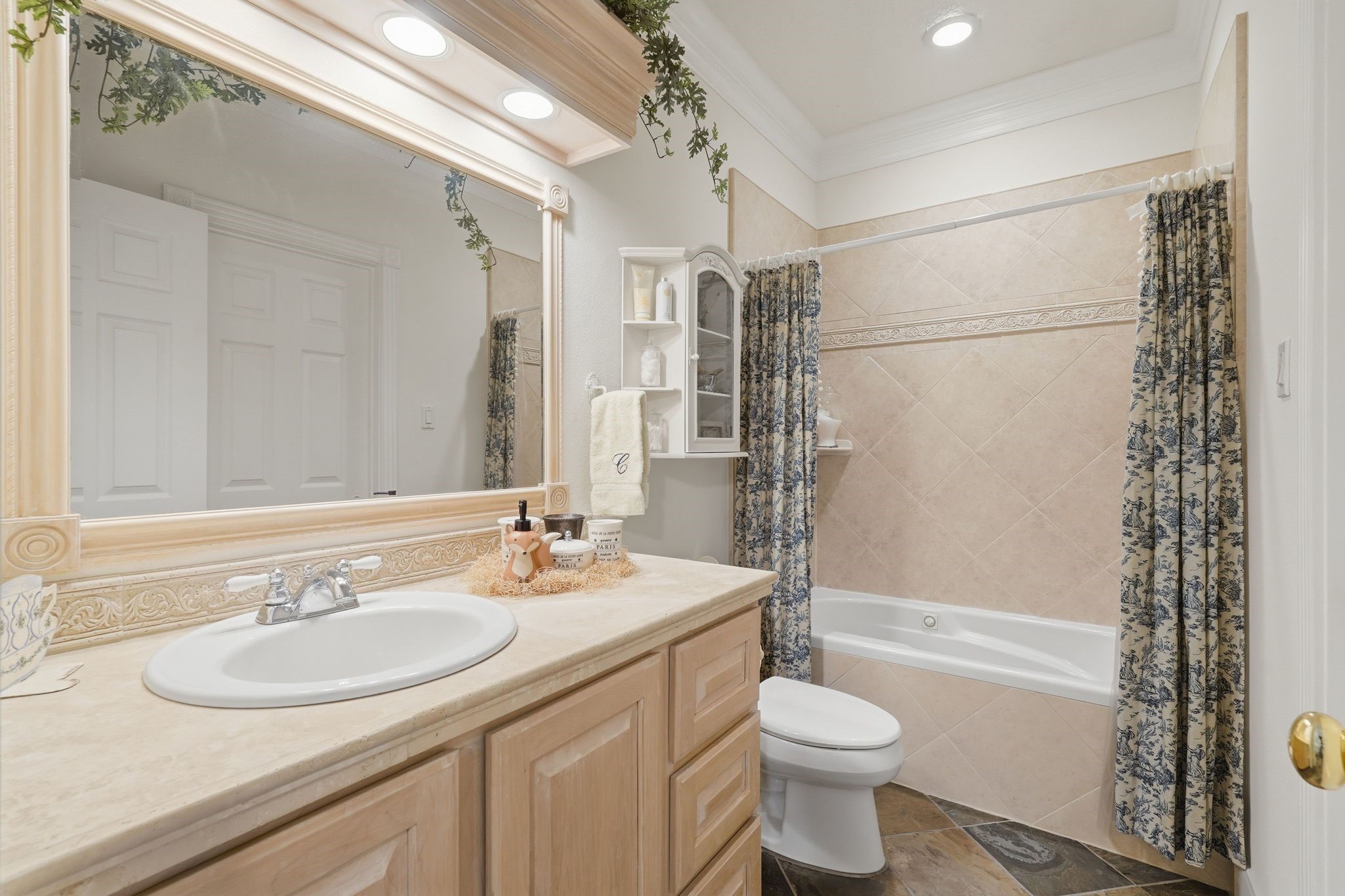 25014 Northampton Terrace Drive Spring, TX 77389 - Photo 37 of 50 The ensuite bathroom with tiled jacuzzi tub/shower combo and large trimmed out mirror with overhead lighting