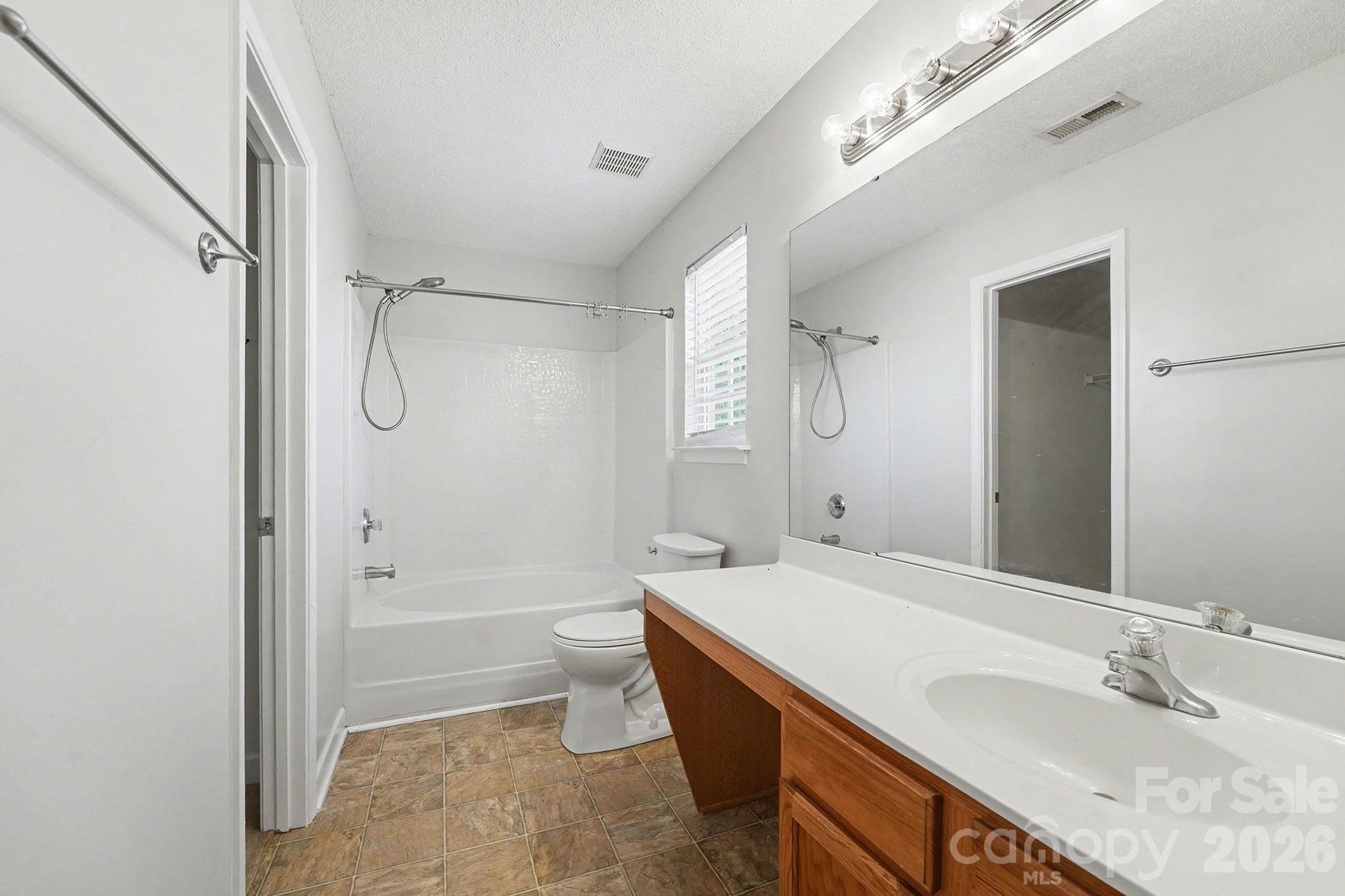 534 Canopy Court Clover, SC 29710 - Photo 12 of 19 a bathroom with a granite countertop sink a toilet and shower