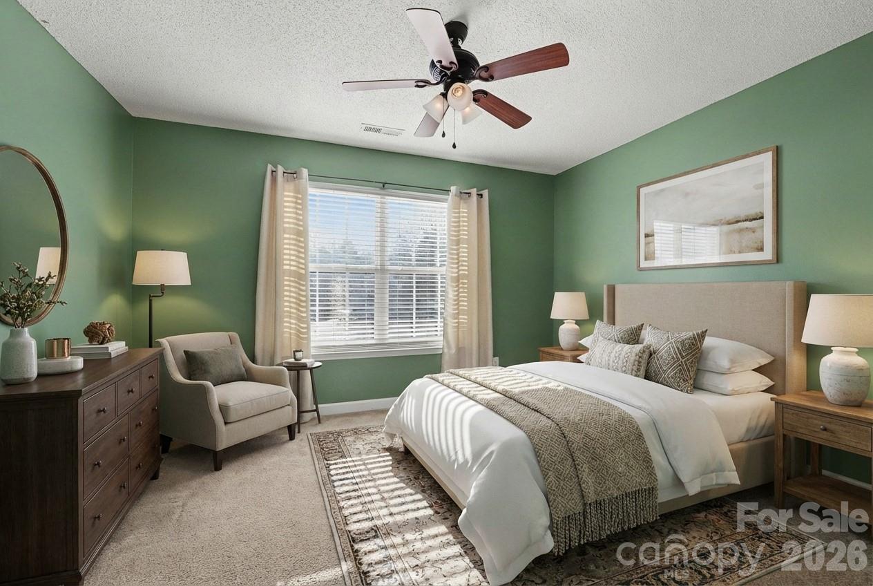 534 Canopy Court Clover, SC 29710 - Photo 12 of 16 a bedroom with a bed and a chandelier
