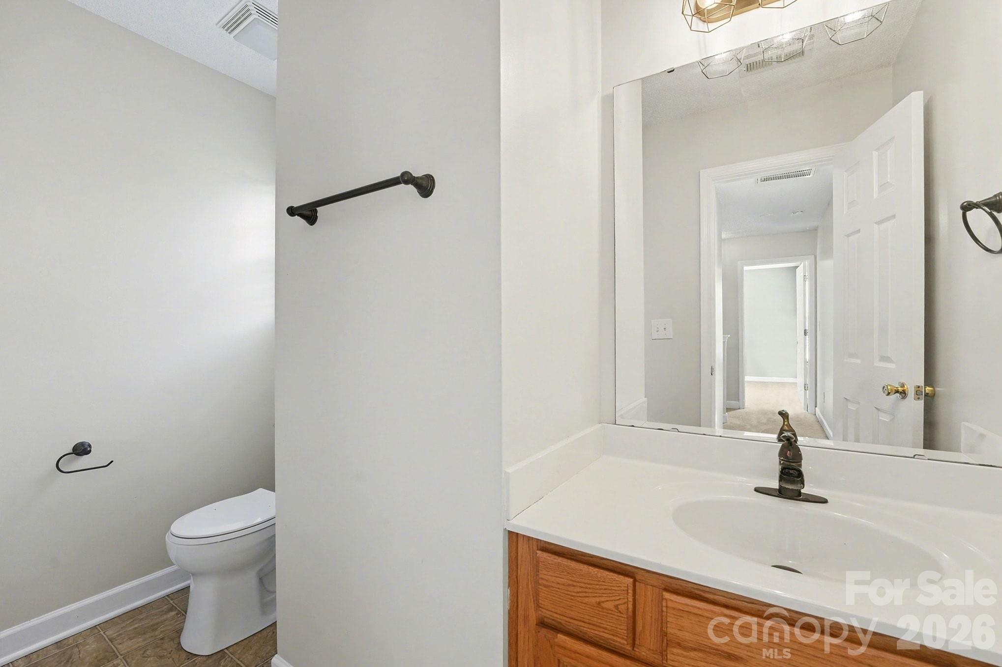 534 Canopy Court Clover, SC 29710 - Photo 14 of 16 a bathroom with a granite countertop sink toilet and shower