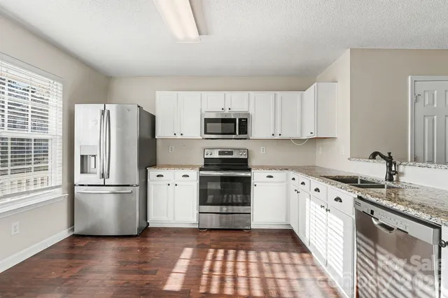 a kitchen with a refrigerator stove and microwave