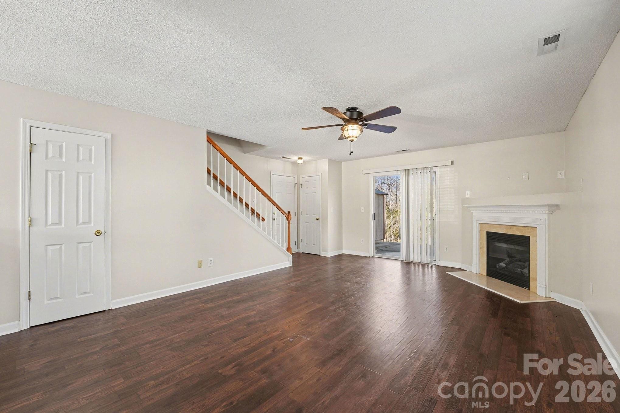 534 Canopy Court Clover, SC 29710 - Photo 6 of 16 a view of an empty room with wooden floor fireplace and a window