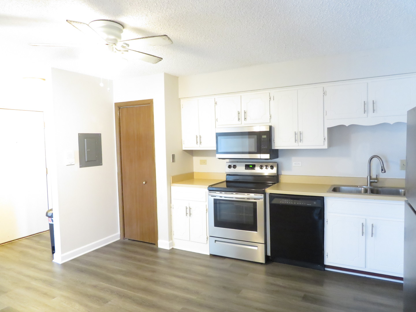 216 Madison Street, Unit 3C Joliet, IL 60435 - Photo 3 of 10 a kitchen with stainless steel appliances granite countertop a sink a stove a refrigerator and cabinets