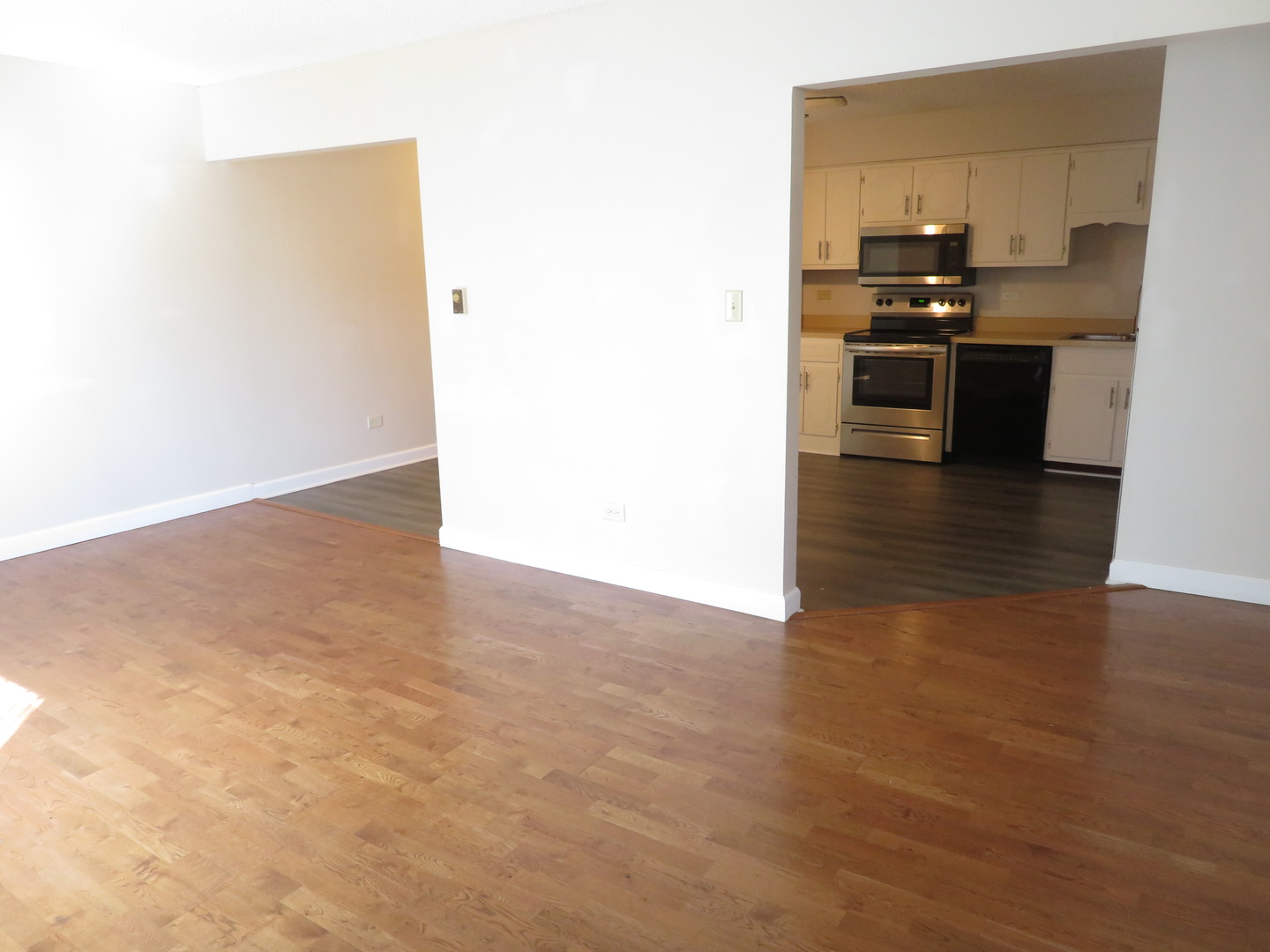 216 Madison Street, Unit 3C Joliet, IL 60435 - Photo 5 of 10 a view of a kitchen with a sink and a refrigerator