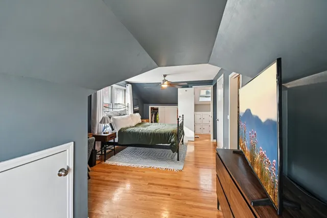 a bedroom with furniture and a wooden floor