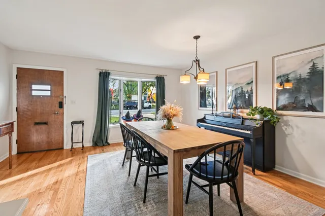 a dining room with furniture a chandelier and window