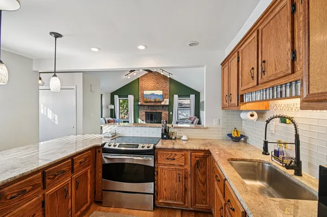 a kitchen with granite countertop a sink and stove
