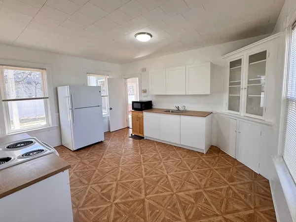 a kitchen with a cabinets and white appliances