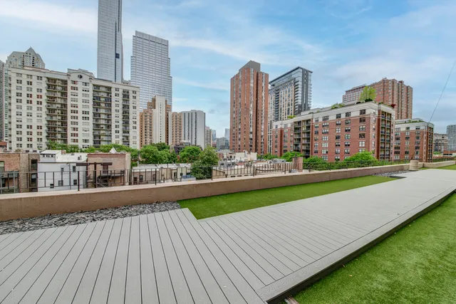 a kitchen with kitchen island a stove a sink and white cabinets