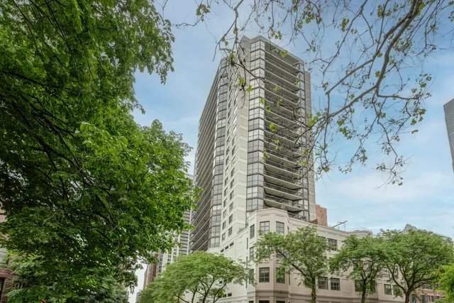 a living room with fireplace furniture and a chandelier
