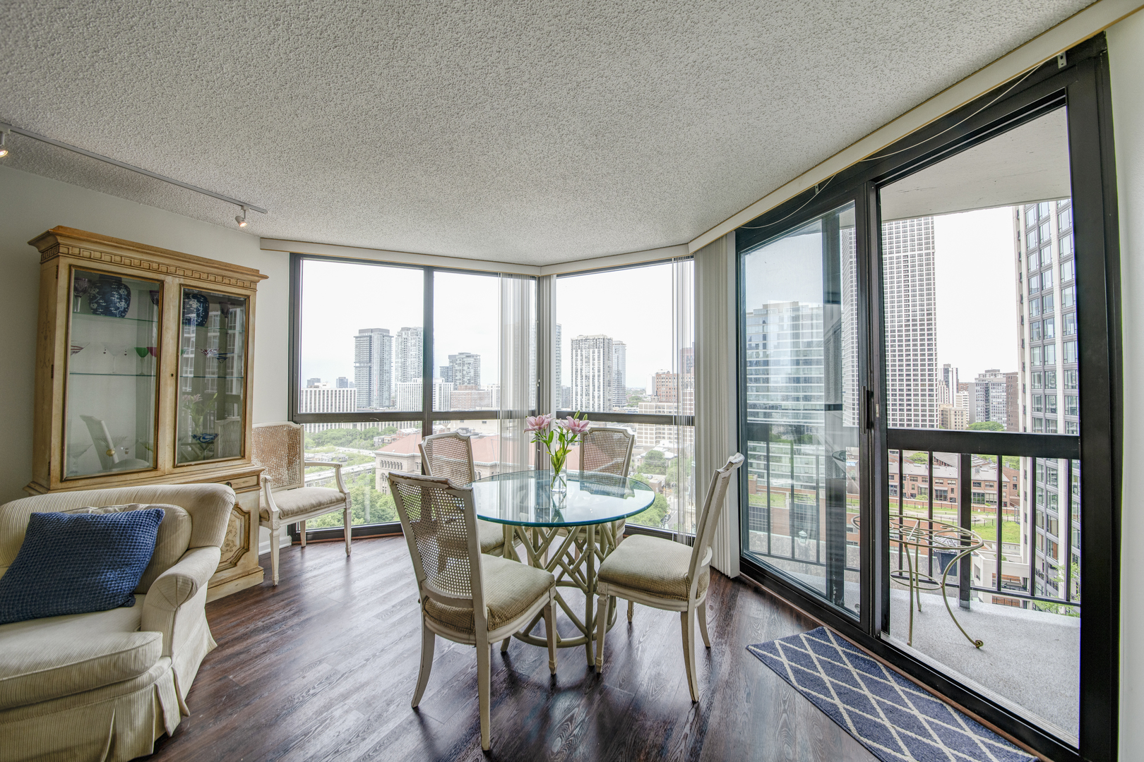 33 West Delaware Place, Unit 19H Chicago, IL 60610 - Photo 6 of 17 a dining room with furniture window and wooden floor