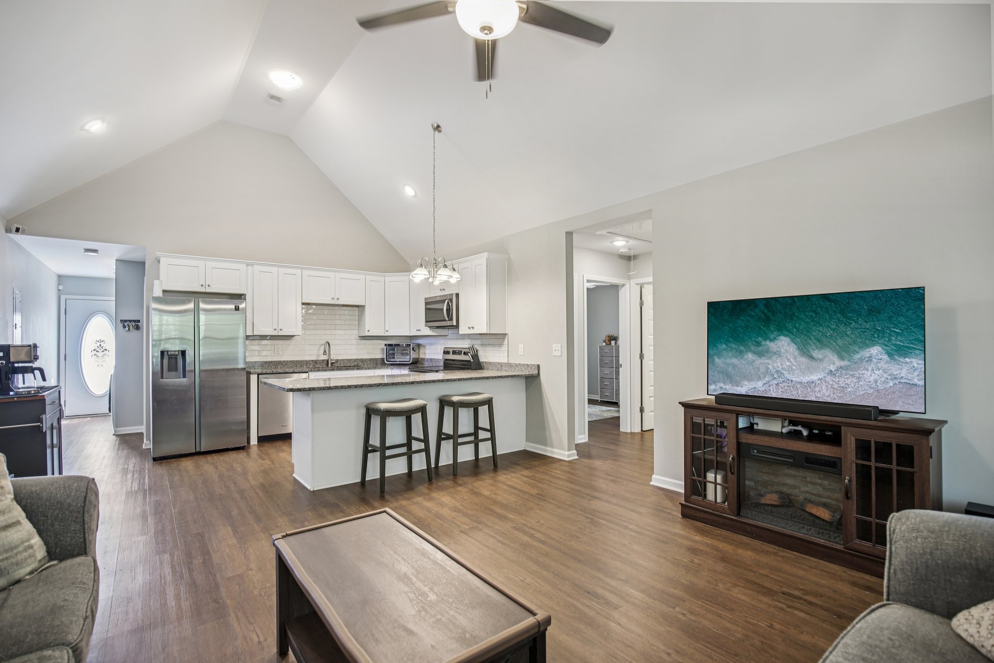 1122 Taylortown Road White Bluff, TN 37187 - Photo 15 of 56 a living room with stainless steel appliances furniture a fireplace a flat screen tv and view kitchen