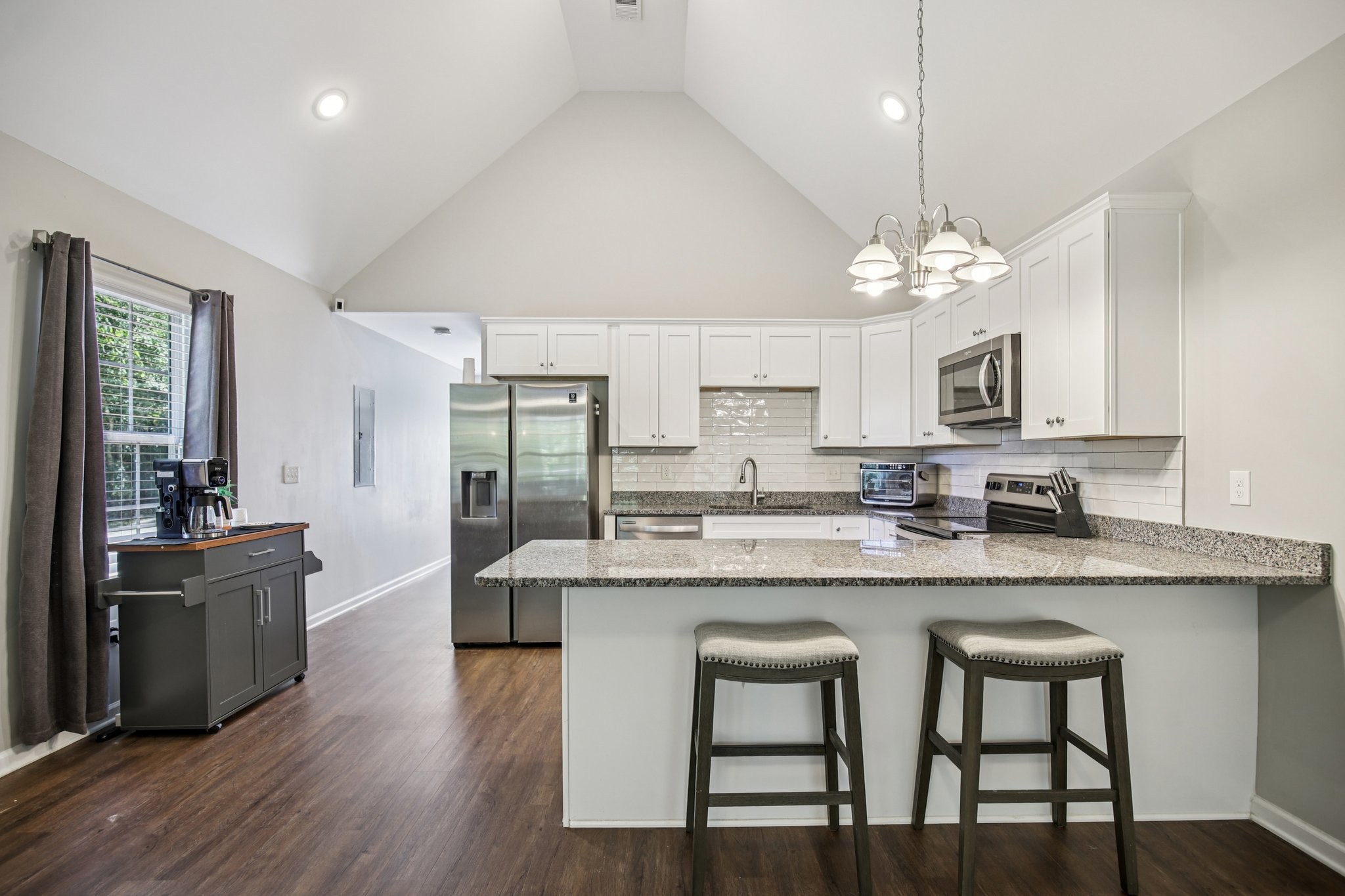 1122 Taylortown Road White Bluff, TN 37187 - Photo 17 of 56 a large kitchen with cabinets chairs and wooden floor