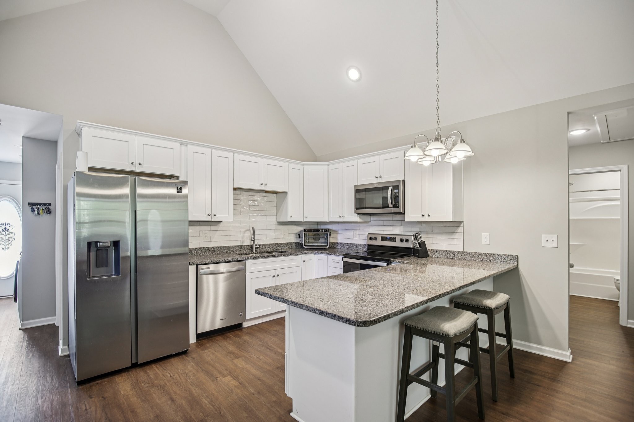 1122 Taylortown Road White Bluff, TN 37187 - Photo 19 of 56 a kitchen with stainless steel appliances a table chairs refrigerator and microwave