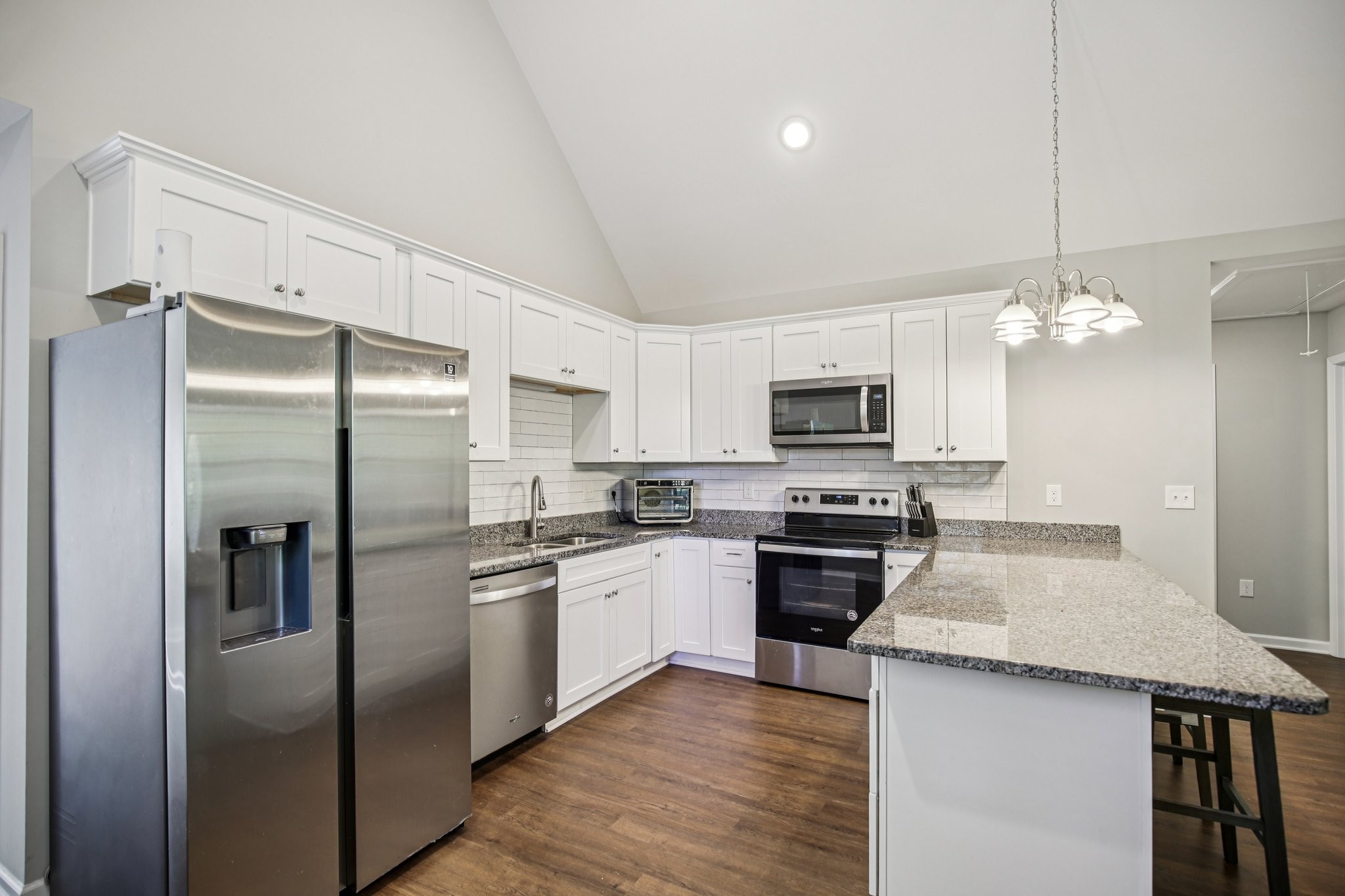 1122 Taylortown Road White Bluff, TN 37187 - Photo 20 of 56 a kitchen with stainless steel appliances granite countertop a refrigerator a stove a sink and a microwave