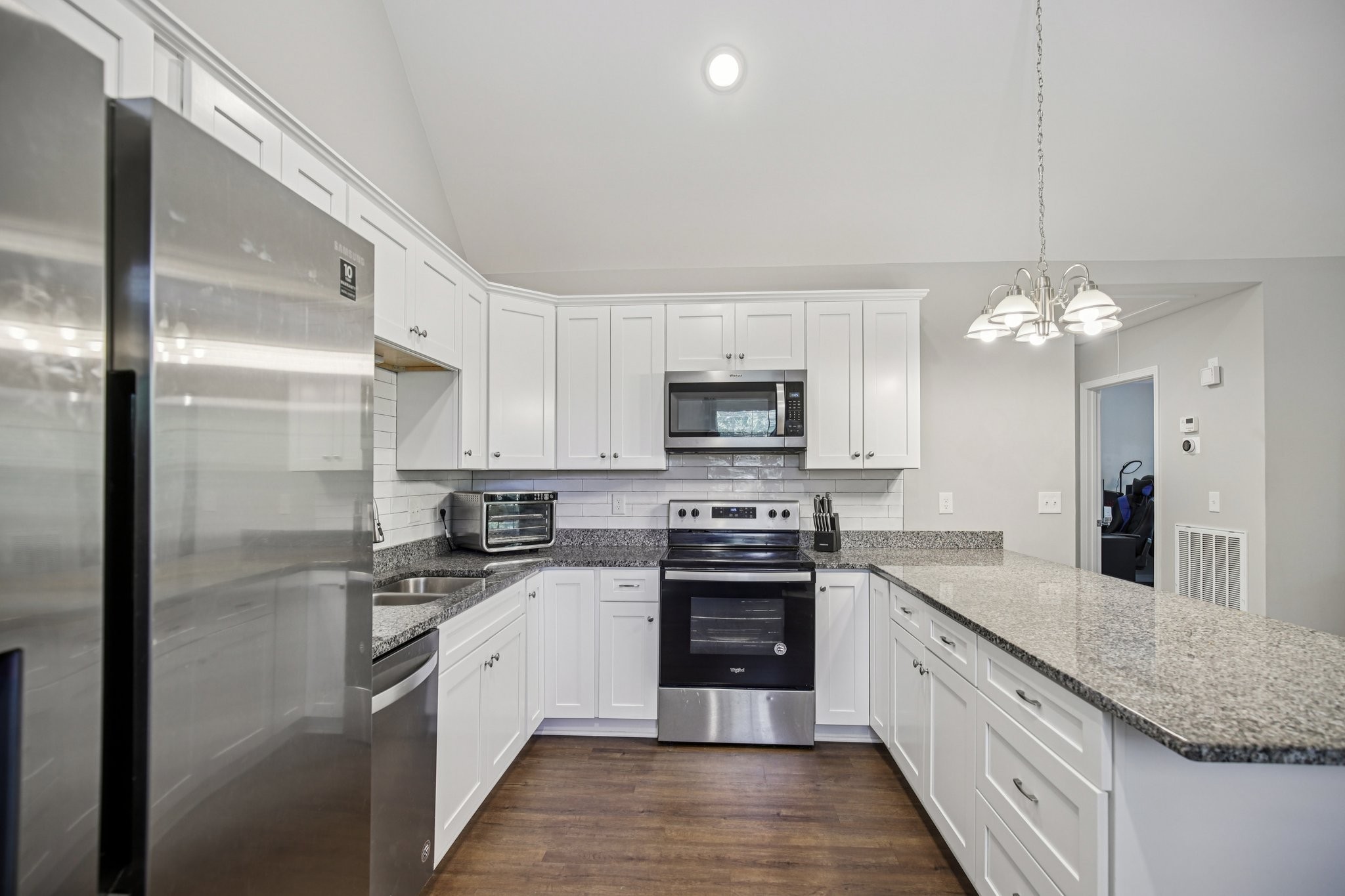 1122 Taylortown Road White Bluff, TN 37187 - Photo 21 of 56 a large kitchen with stainless steel appliances granite countertop a sink a stove a refrigerator and a granite counter tops