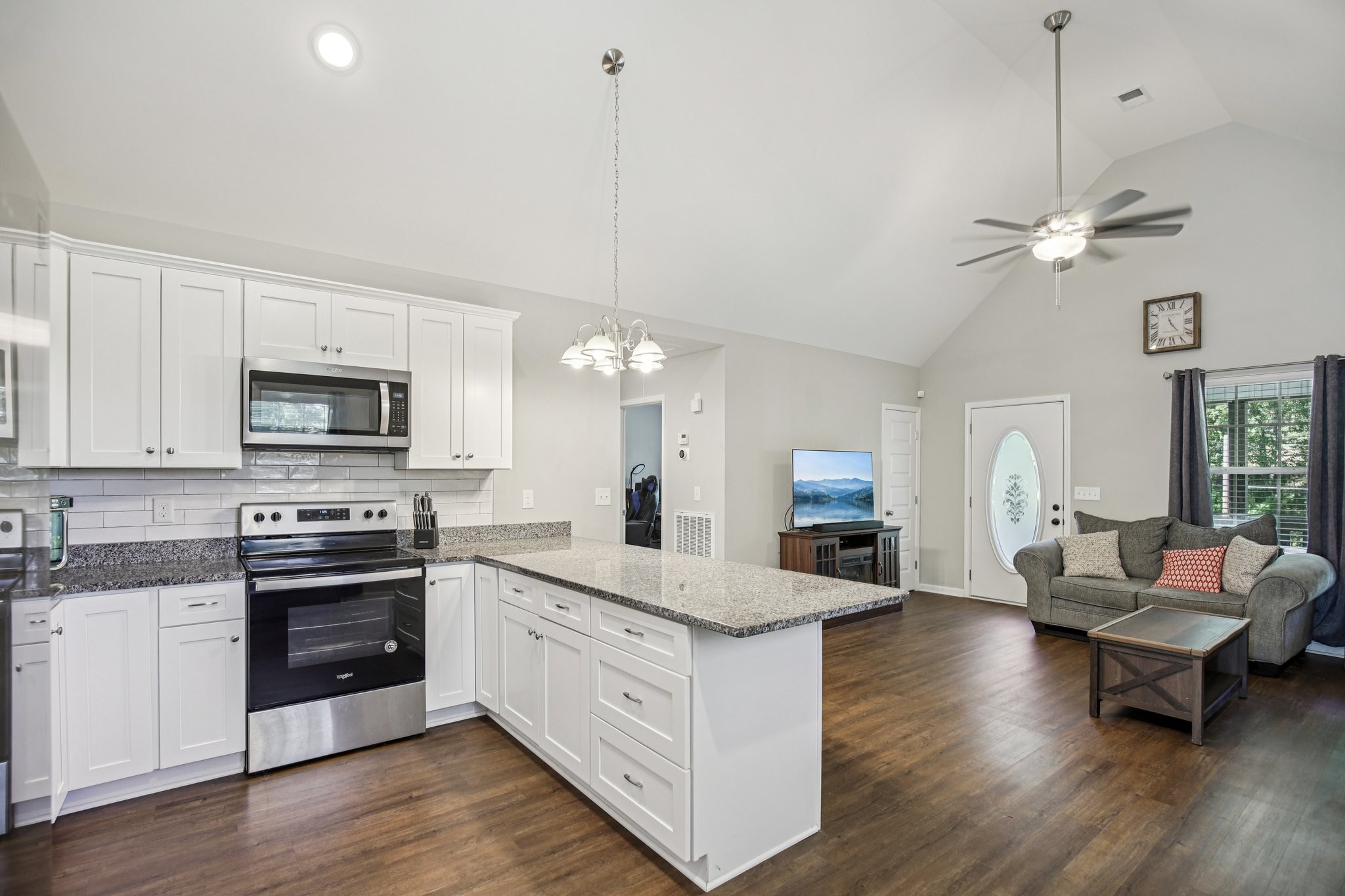 1122 Taylortown Road White Bluff, TN 37187 - Photo 22 of 56 a large kitchen with stainless steel appliances kitchen island granite countertop a stove a sink dishwasher a dining table and chairs with wooden floor