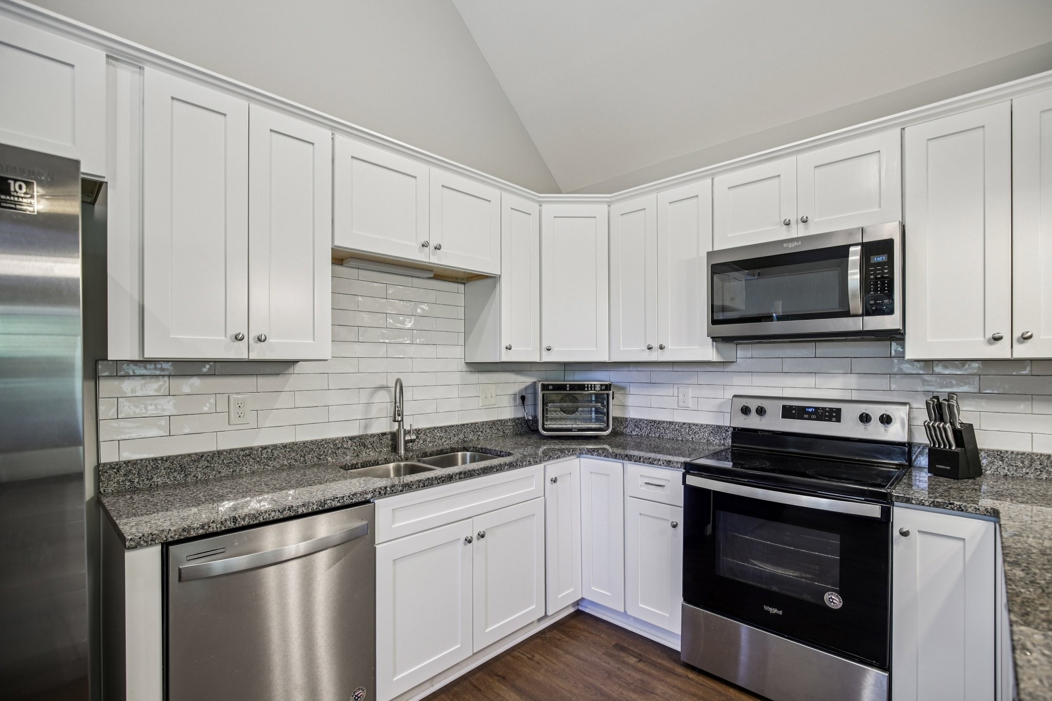 1122 Taylortown Road White Bluff, TN 37187 - Photo 25 of 56 a kitchen with stainless steel appliances granite countertop white cabinets granite counter tops and a wooden floors