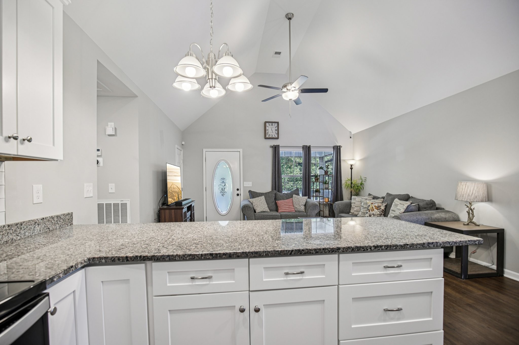 1122 Taylortown Road White Bluff, TN 37187 - Photo 27 of 56 a kitchen with granite countertop white cabinets and chandelier