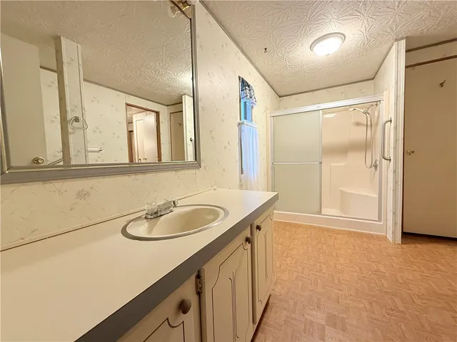 a bathroom with a bathtub and shower