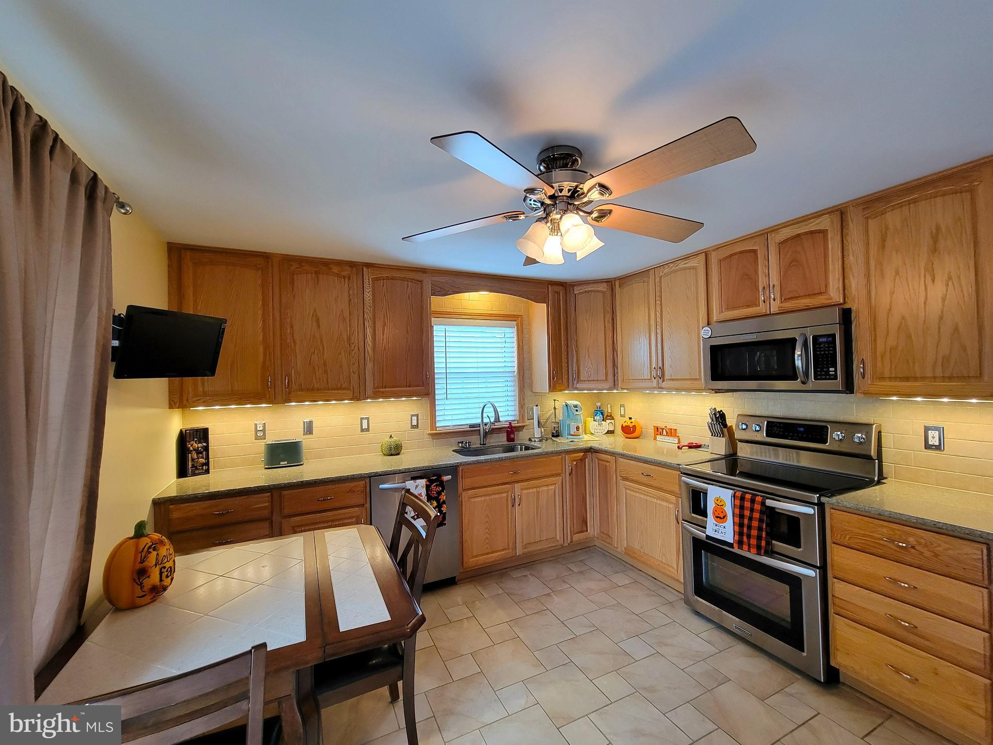 139 Mussetta Street Hanover, PA 17331 - Photo 17 of 63 a kitchen with stainless steel appliances a stove sink microwave and cabinets