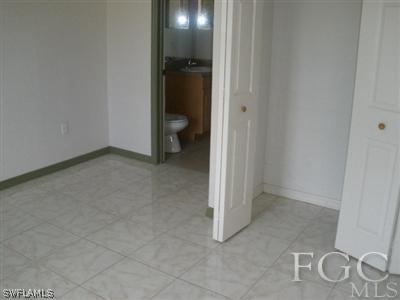 4713 28th Street Southwest Lehigh Acres, FL 33973 - Photo 3 of 8 an empty room and a bathroom with a toilet