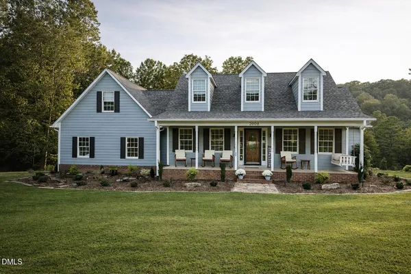 a front view of house with yard outdoor seating and barbeque oven
