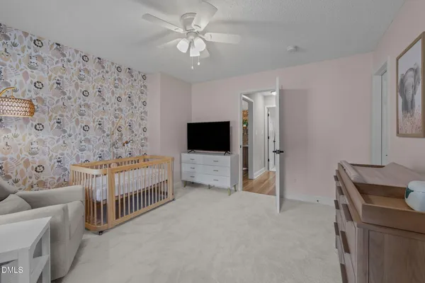 a bedroom with furniture and a flat screen tv