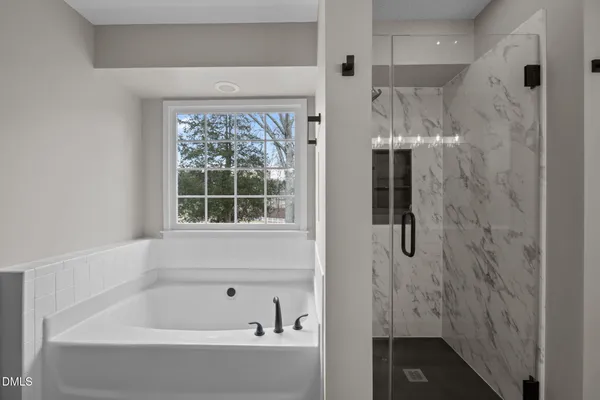 a bathroom with a bathtub and shower