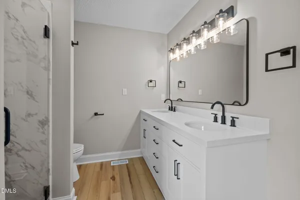 a bathroom with a double vanity sink mirror and double