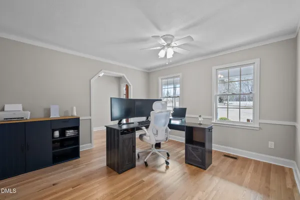 a view of a workspace with furniture and a window